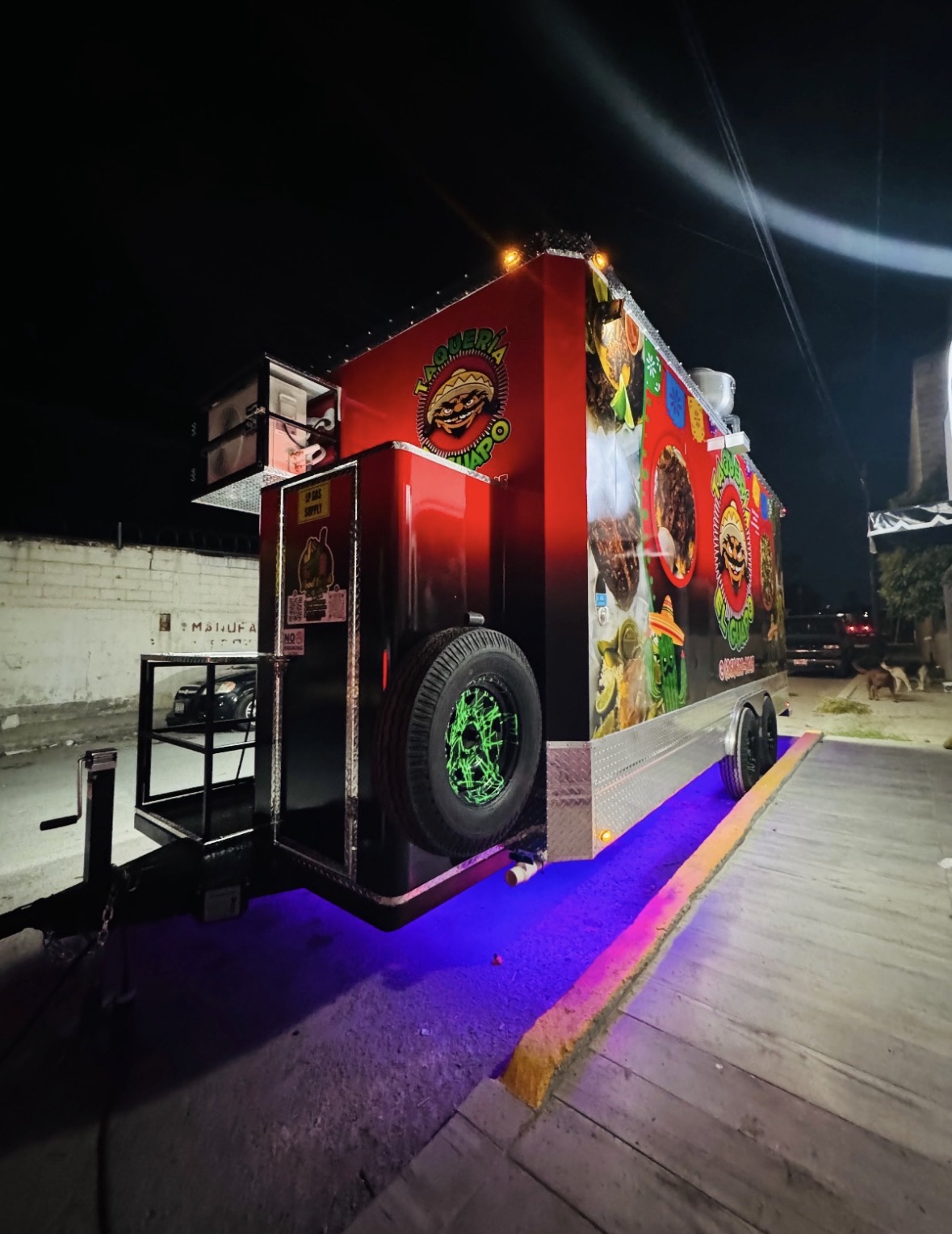 Rear view of a custom food trailer with wrap