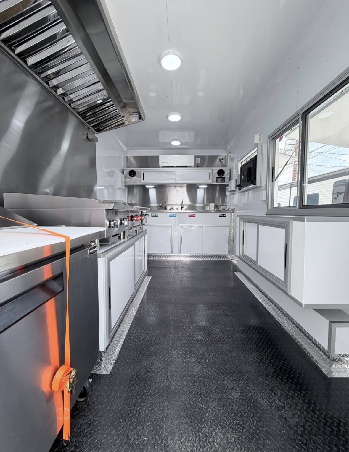 Food trailer kitchen line with hood, griddle and refrigeration