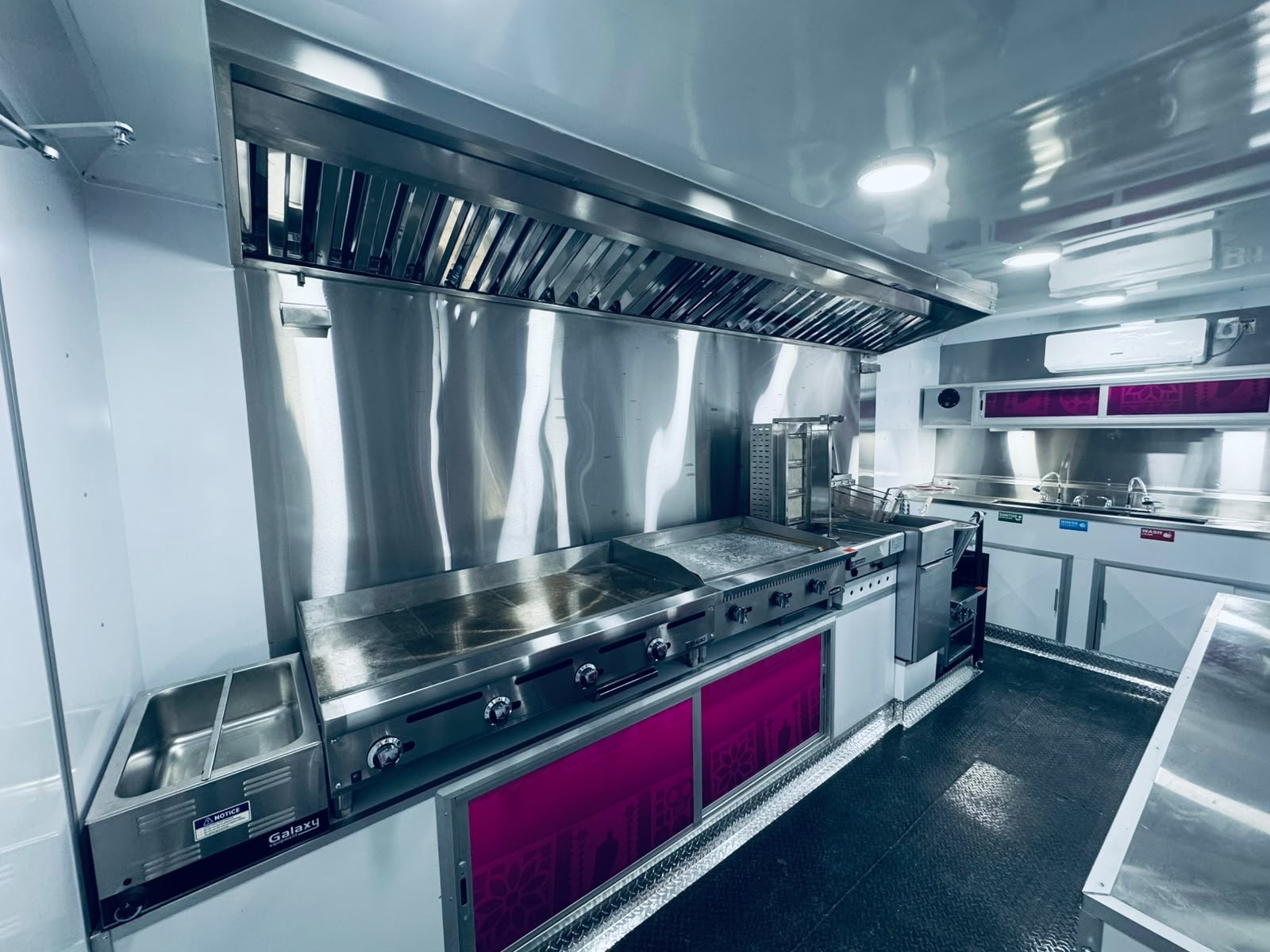 Custom trailer kitchen line with hood, fryer and sinks