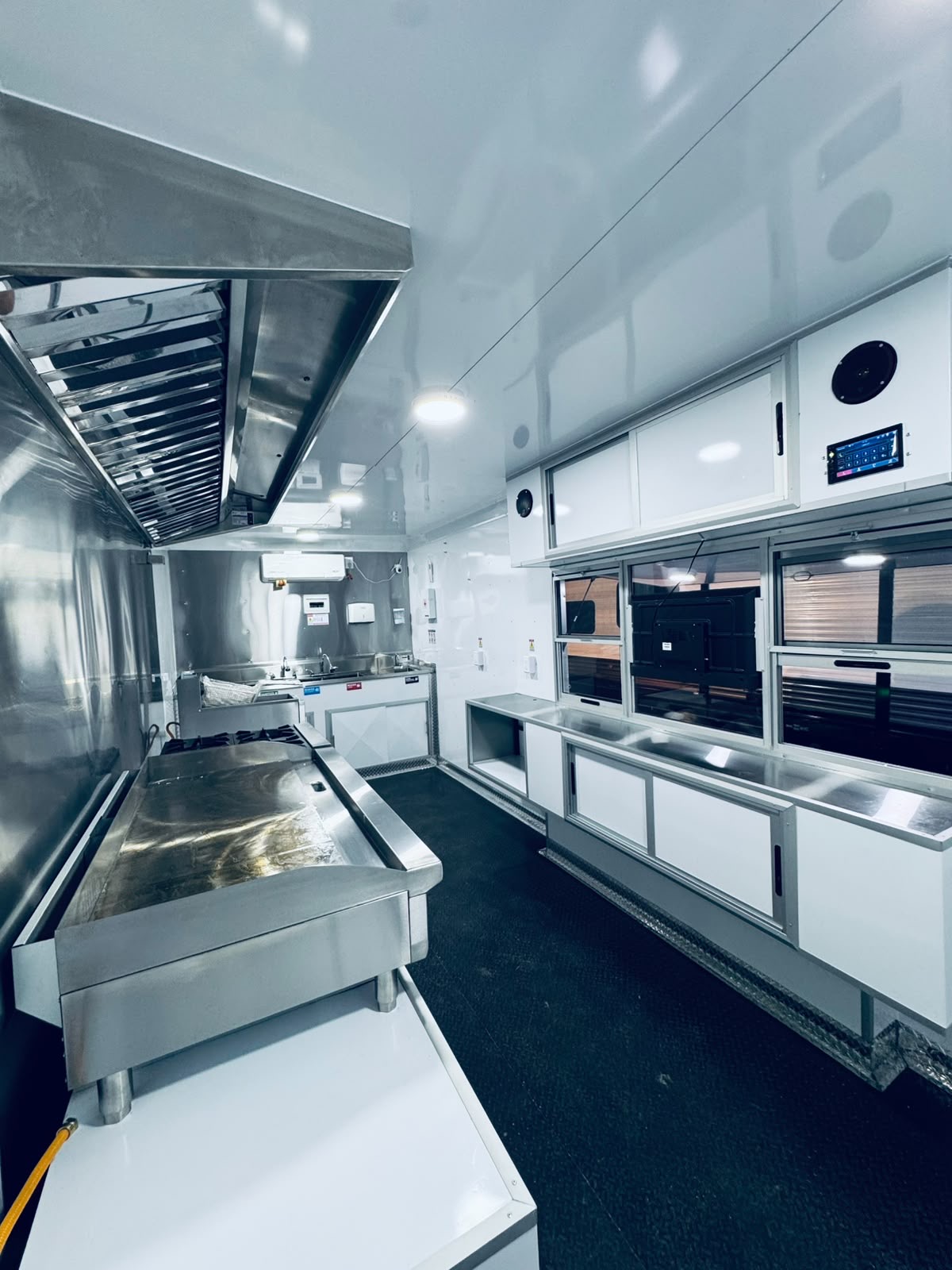 Stainless steel kitchen interior with hood and griddle