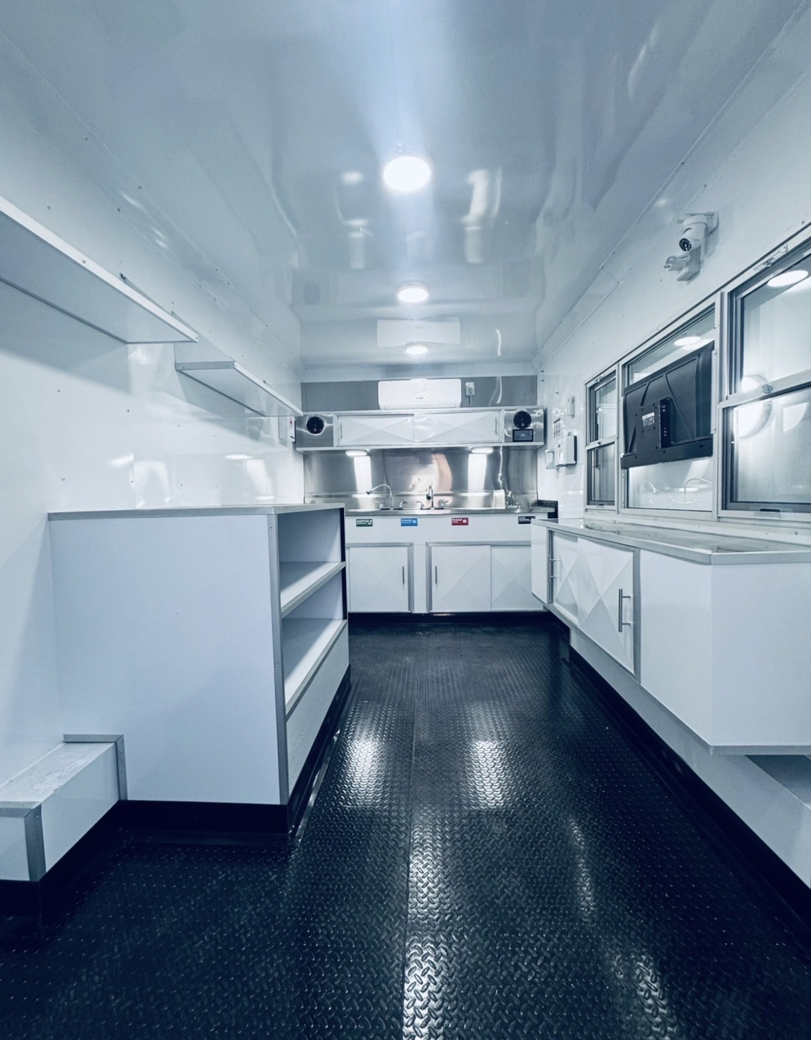 All-white custom trailer interior with stainless prep line